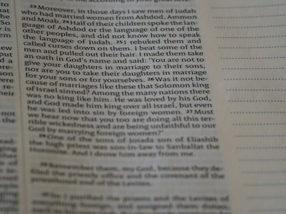 A close-up of an open English textbook with notes and a pen.