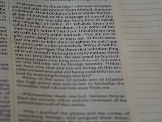 A close-up view of an open book page with printed text in English. The focus is on a particular section of text on the left, while the right side displays blank lines for note-taking.