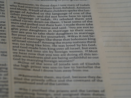 A close-up view of an open book page with printed text in English. The focus is on a particular section of text on the left, while the right side displays blank lines for note-taking.