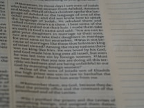 A close-up view of an open book page with printed text in English. The focus is on a particular section of text on the left, while the right side displays blank lines for note-taking.