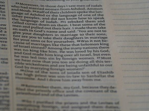 A close-up view of an open book page with printed text in English. The focus is on a particular section of text on the left, while the right side displays blank lines for note-taking.