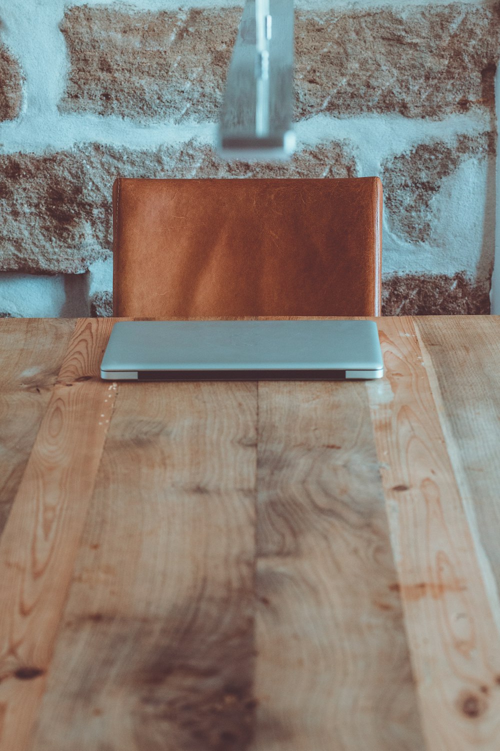 a laptop computer sitting on top of a wooden table