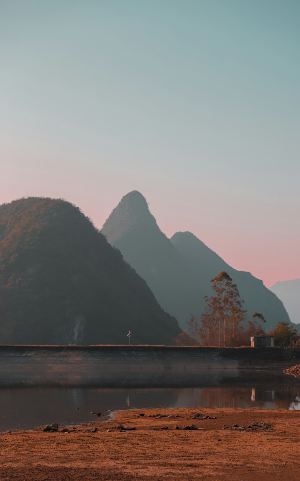 a mountain range with a body of water in the foreground