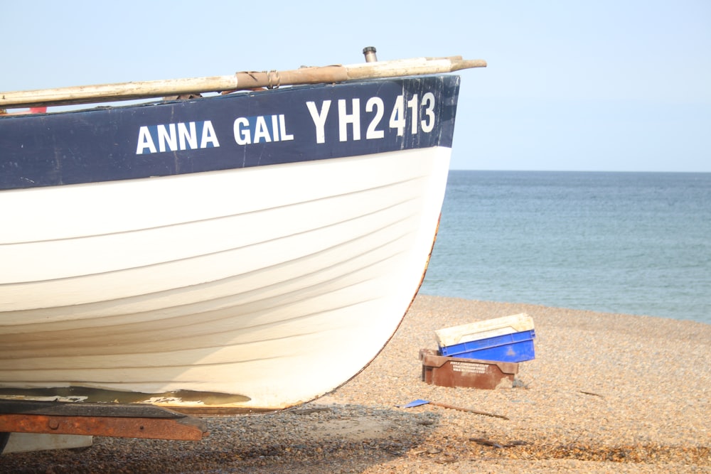 a boat sitting on top of a sandy beach