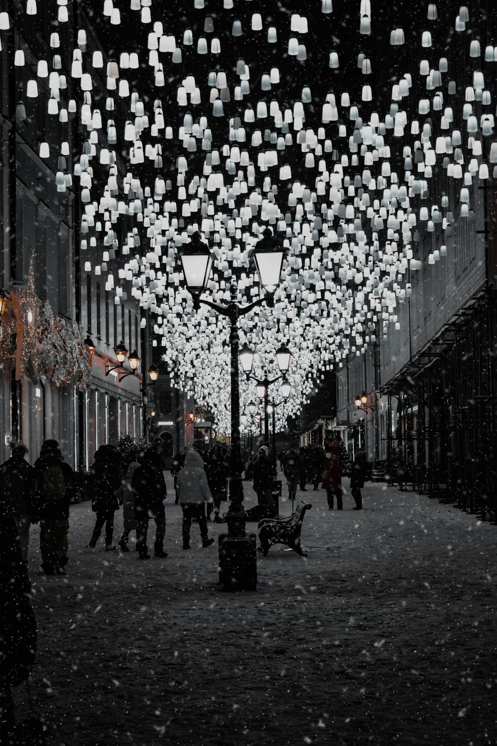 a group of people walking down a snow covered street