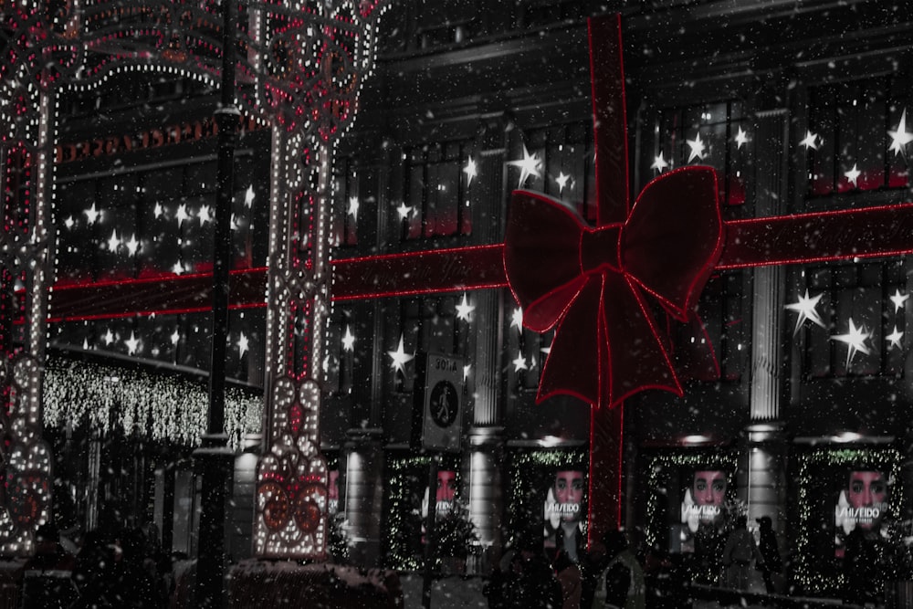 a large red bow hanging from the side of a building