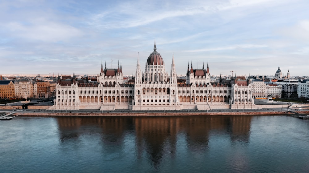 a large white building sitting on top of a river