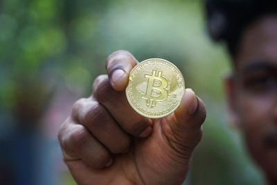 a man holding a bit coin in his hand
