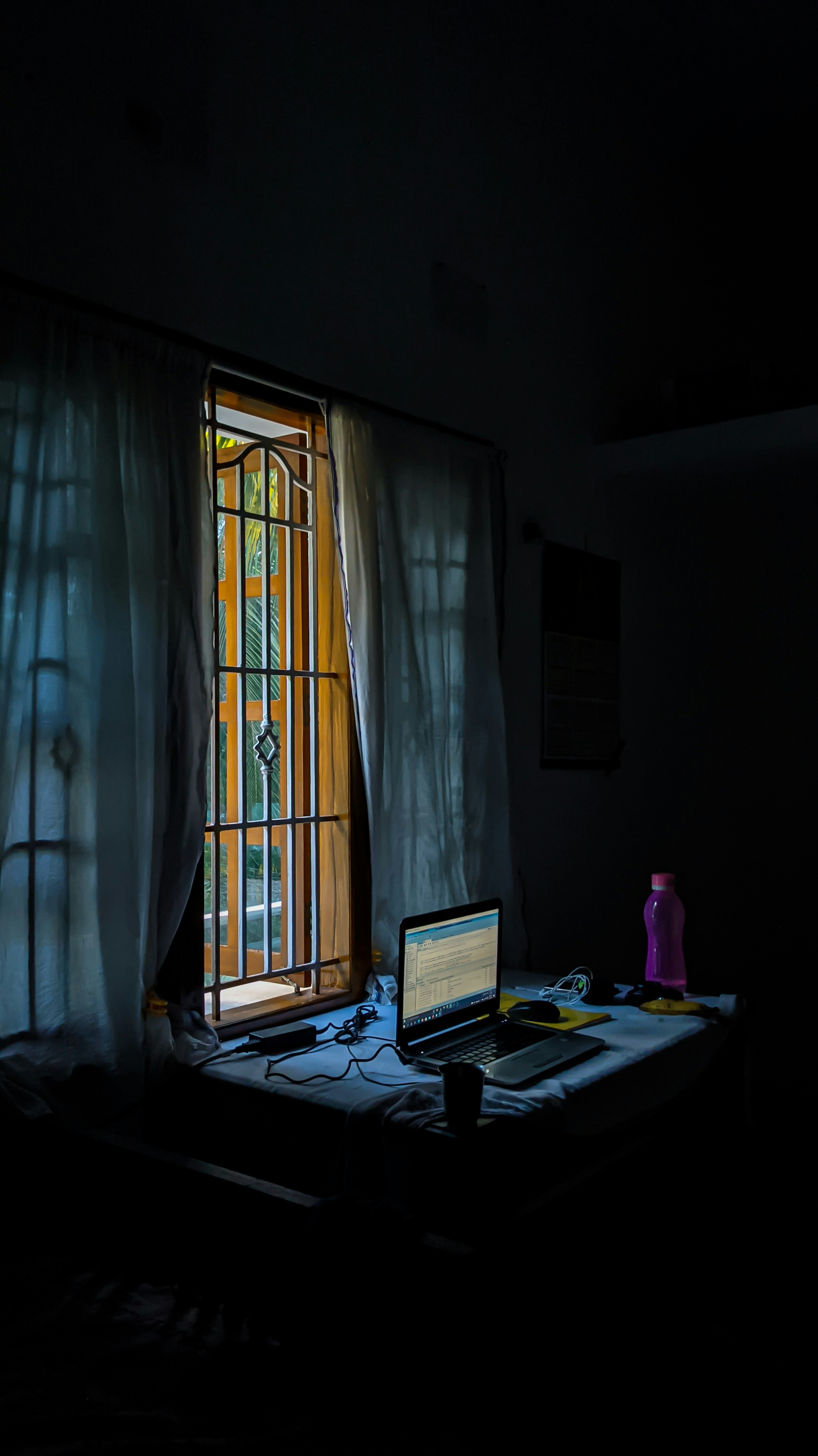 Laptop on white desk, bright studio, open lid