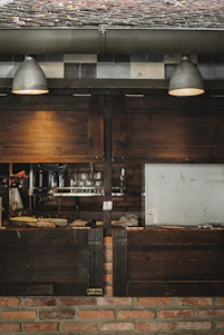 Cozy rustic kitchen scene with warm lighting and traditional cooking utensils on wooden shelves