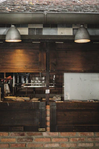 A warm, modern kitchen showroom scene with natural wood tones and soft lighting.