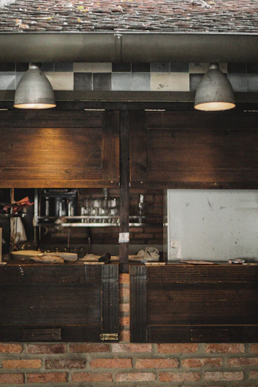 Cozy rustic kitchen scene with warm lighting and traditional cooking utensils on wooden shelves