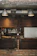 A rustic wooden kitchen counter adorned with deep wood-toned utensils and soft moss accents.