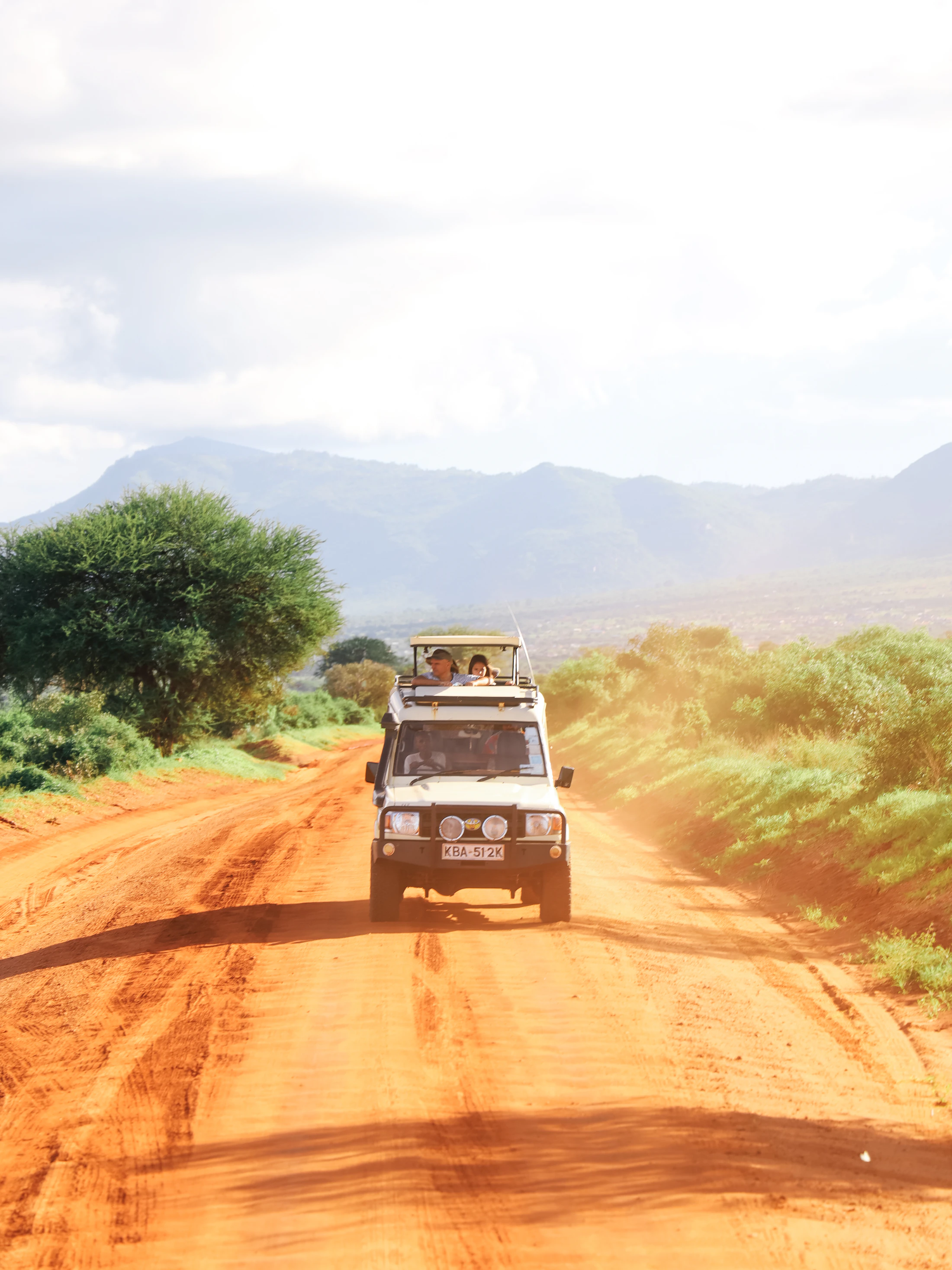 Safari vehicle travelling through the African savanna