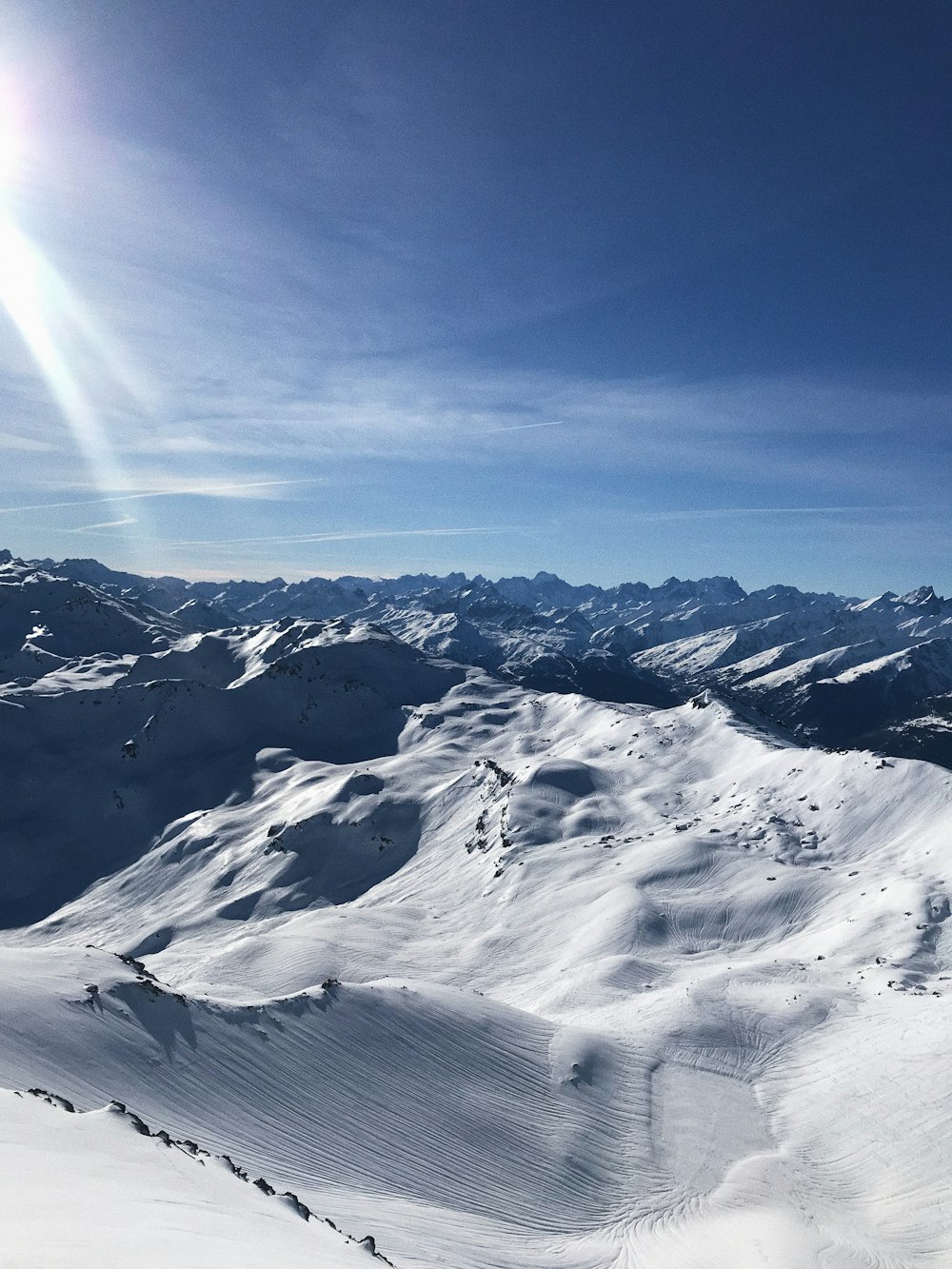 a man riding skis on top of a snow covered slope