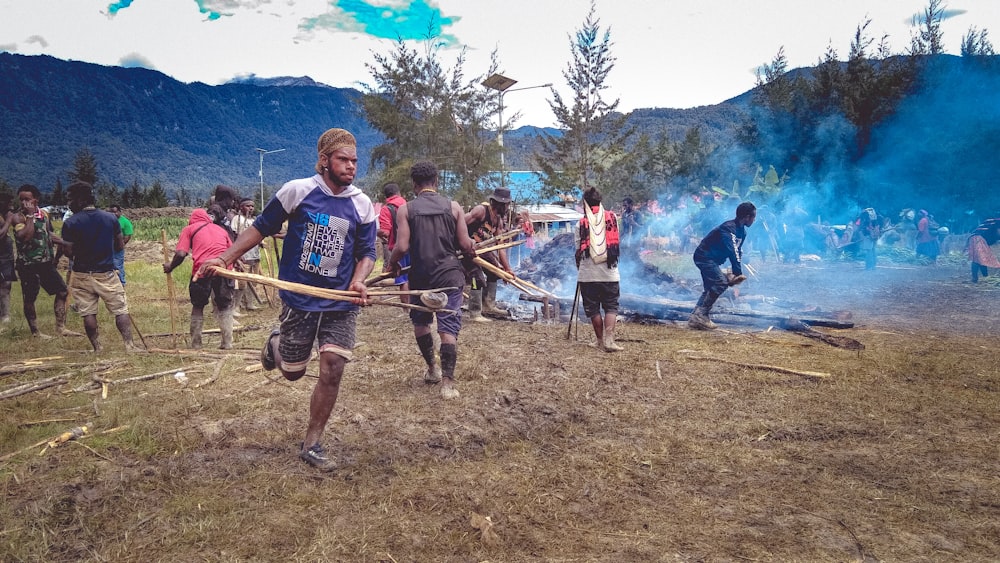 a group of people standing around a fire