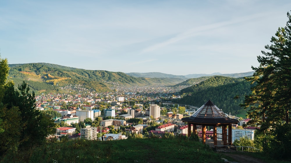 a scenic view of a city in the mountains