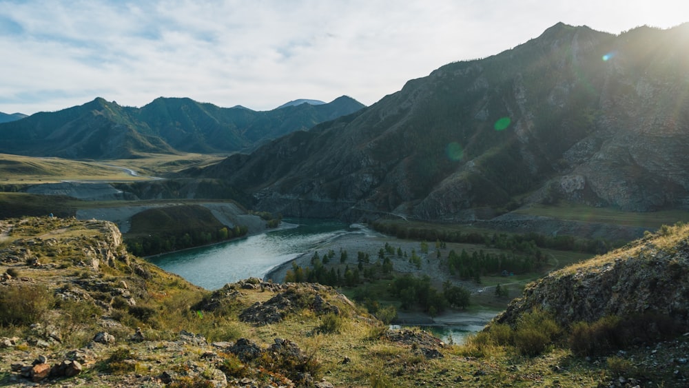 the sun shines brightly on a mountain valley