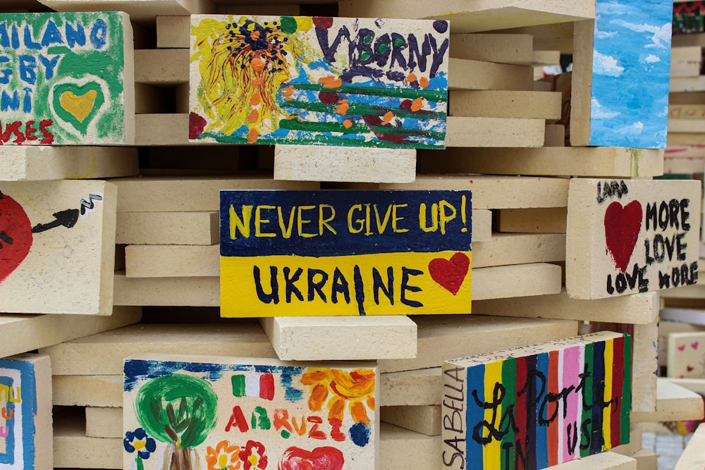 a pile of wooden blocks with different paintings on them