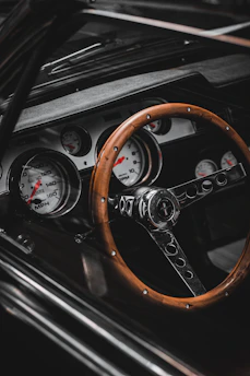 a car dashboard with a steering wheel and gauges