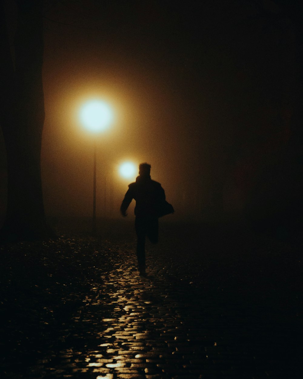 a person walking down a street at night