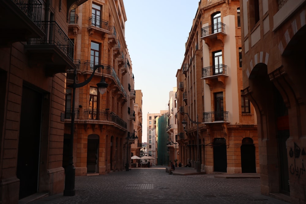 a narrow city street lined with tall buildings