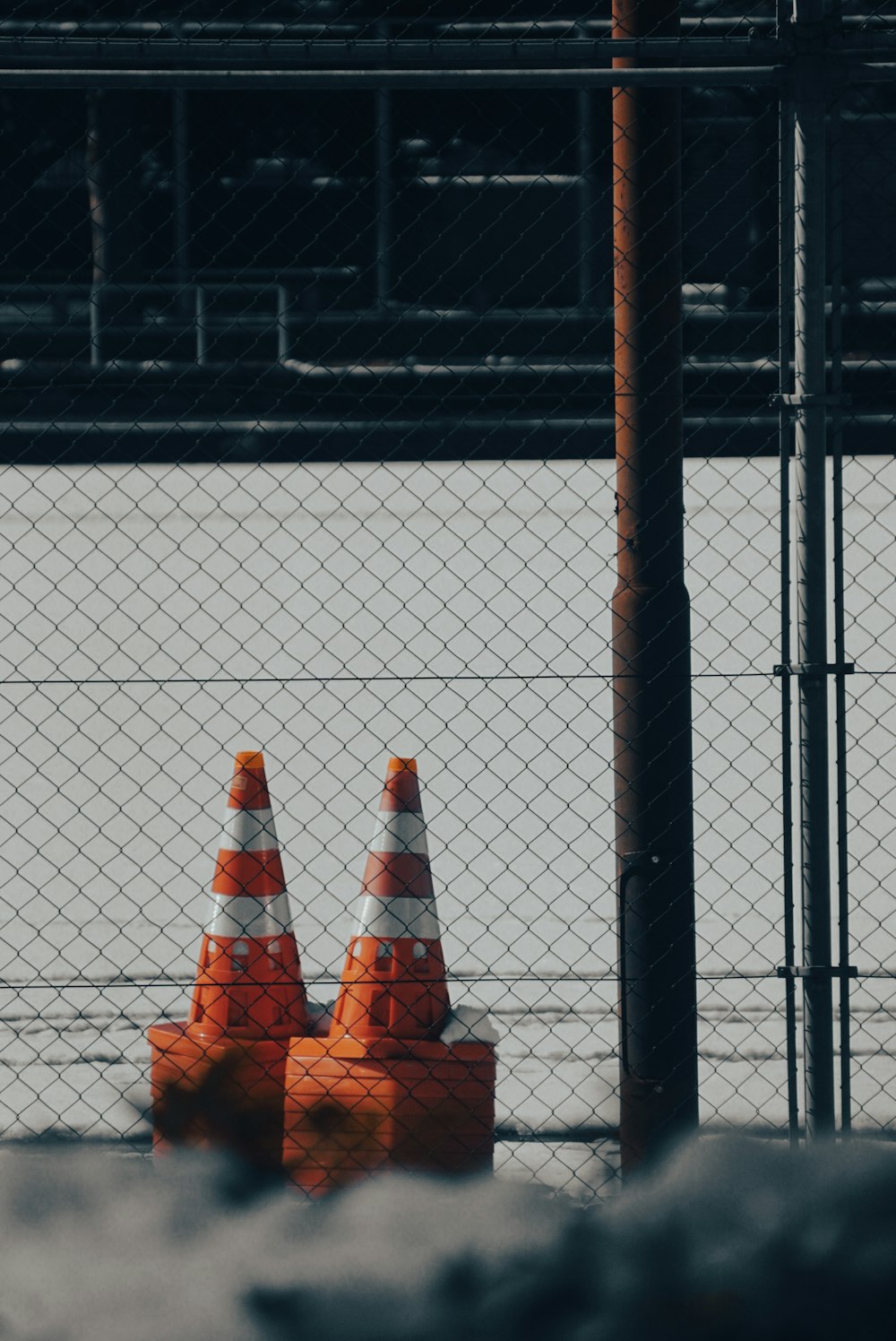 a couple of orange cones sitting on top of a road