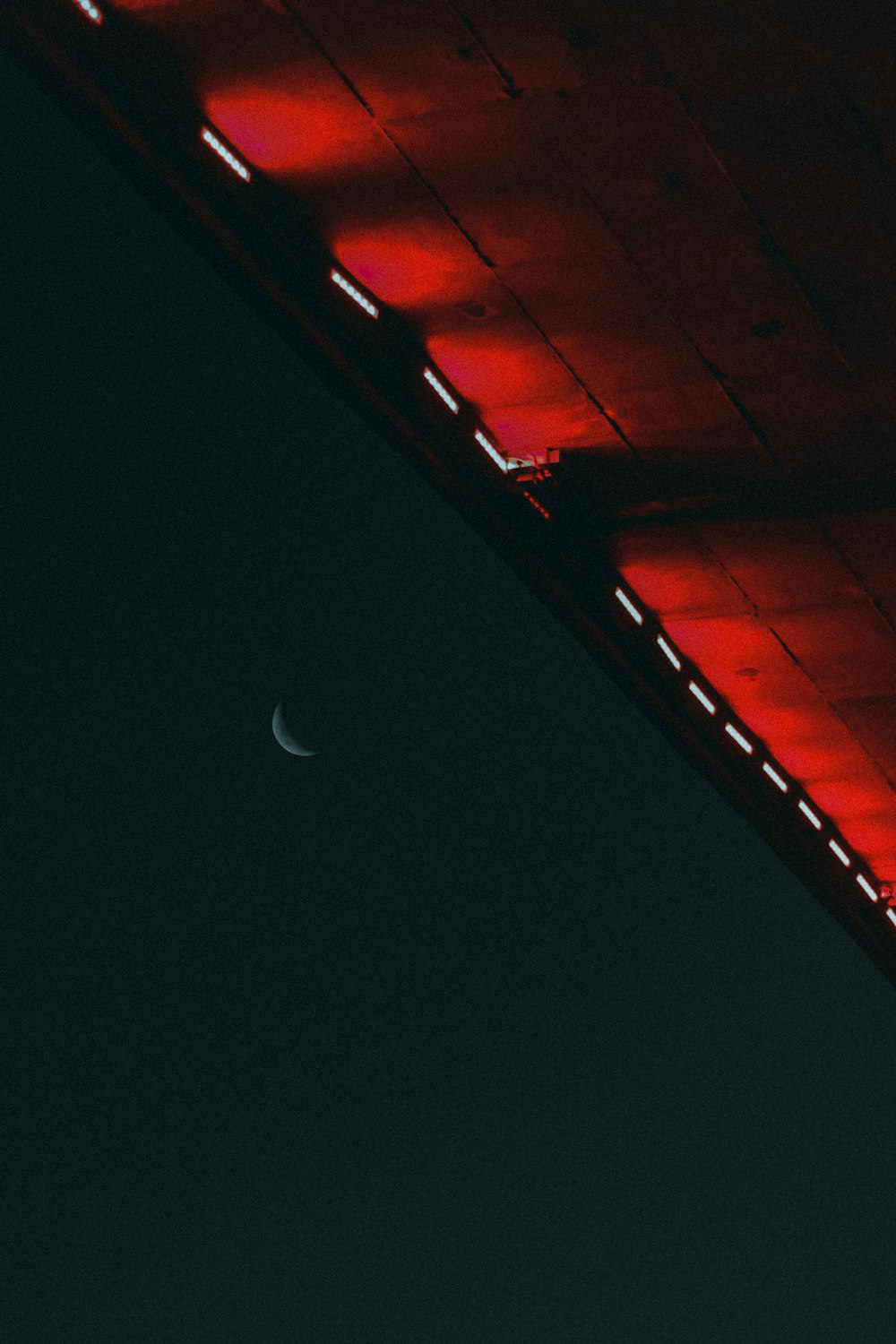 a view of a bridge with a half moon in the distance