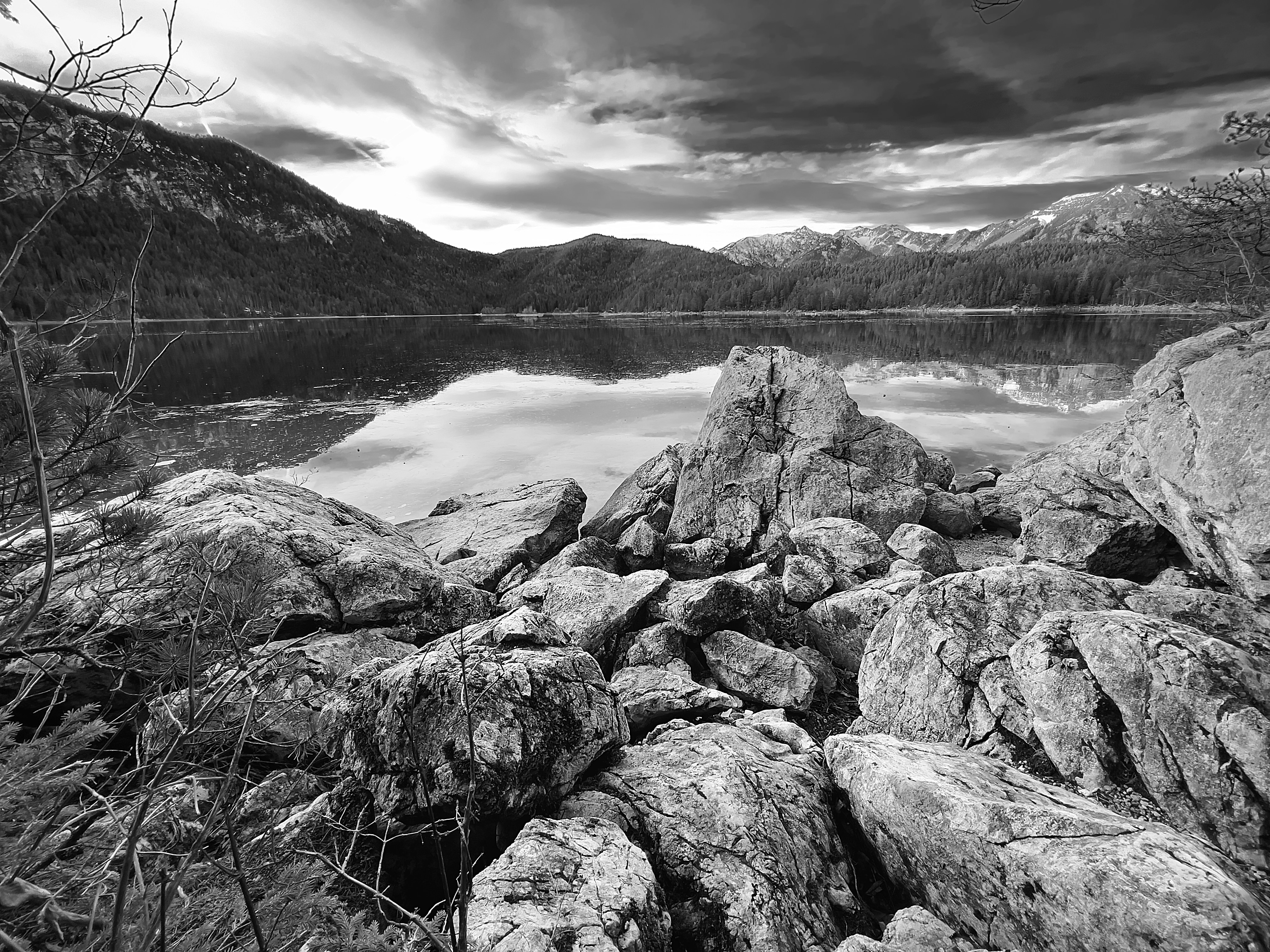 a black and white photo of a mountain lake