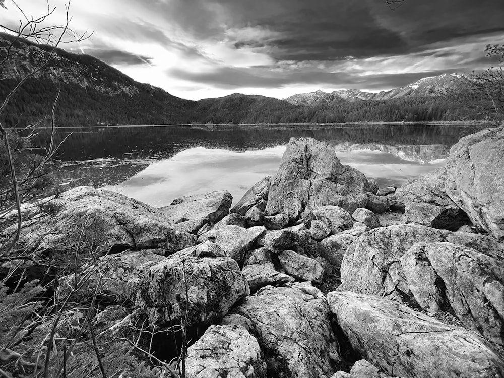 a black and white photo of a mountain lake