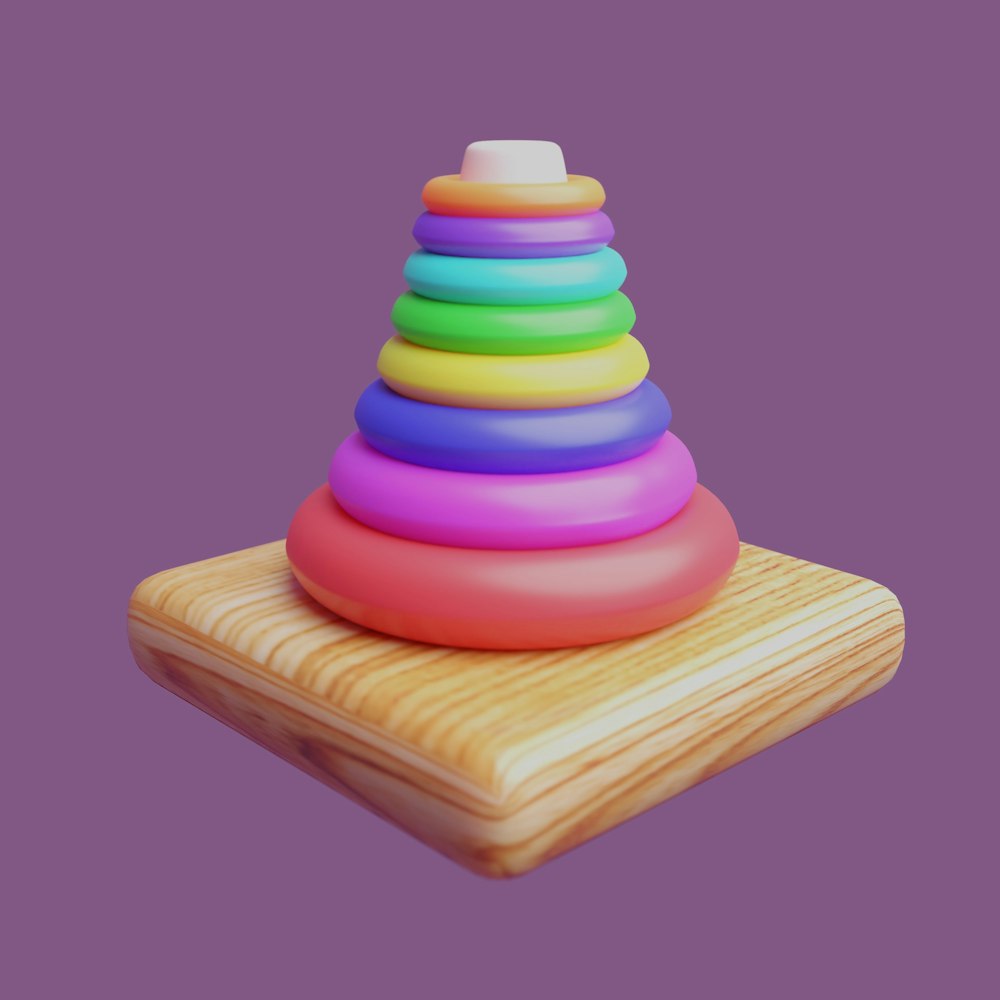 a wooden block with a multicolored pyramid on top of it