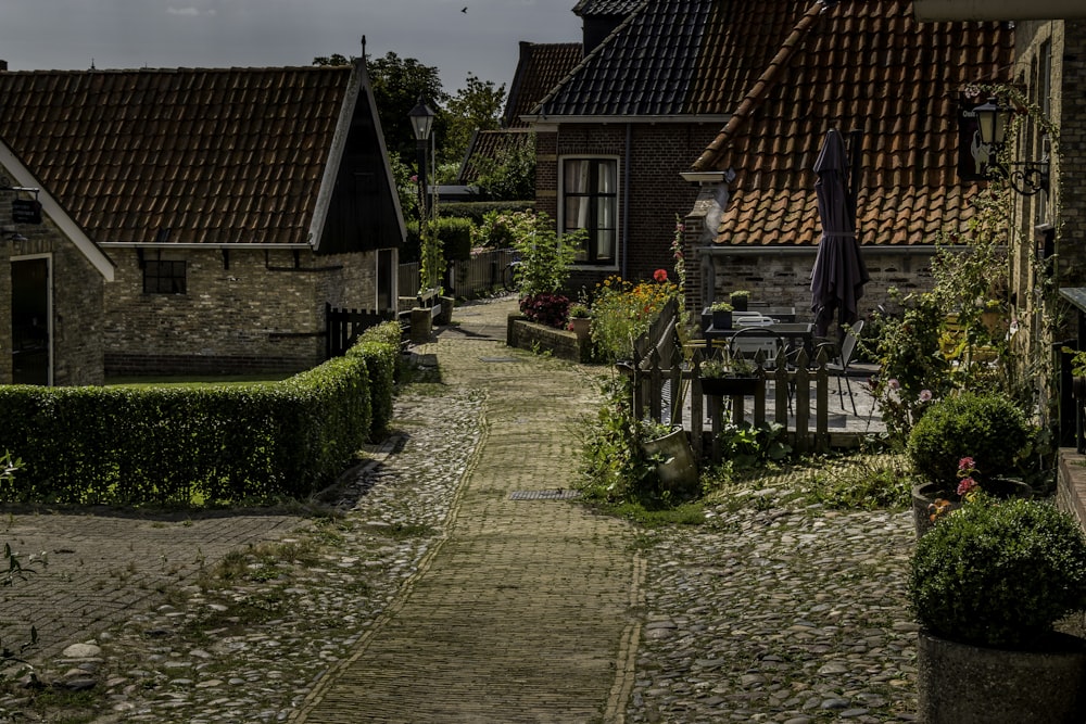 a cobblestone street lined with small houses