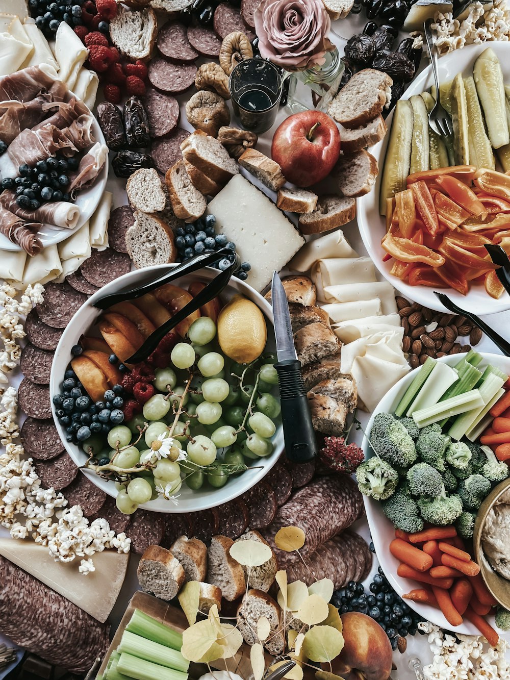 a platter of meats, cheeses, fruits and vegetables