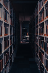 a dimly lit library with rows of books