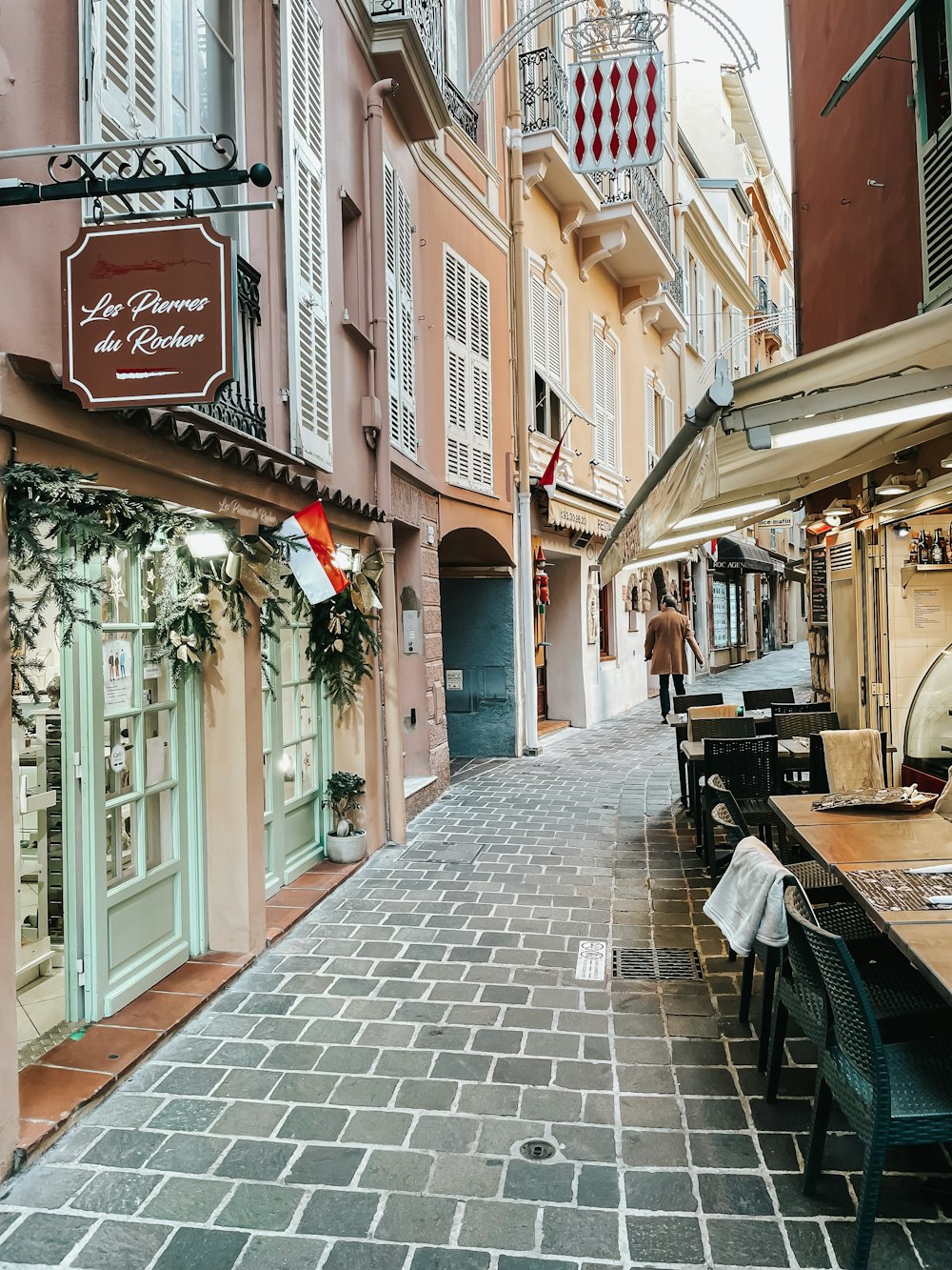 a cobblestone street lined with tables and chairs