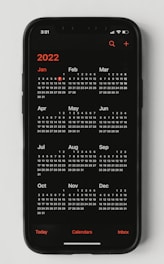 A calendar with marked appointments and a smartphone displaying a booking app.