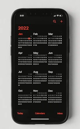 A sleek smartphone screen showing a calendar with scheduled Telegram posts highlighted.