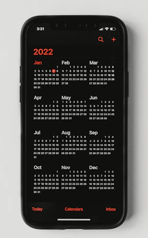 Close-up of a calendar with notifications popping up on a smartphone screen.