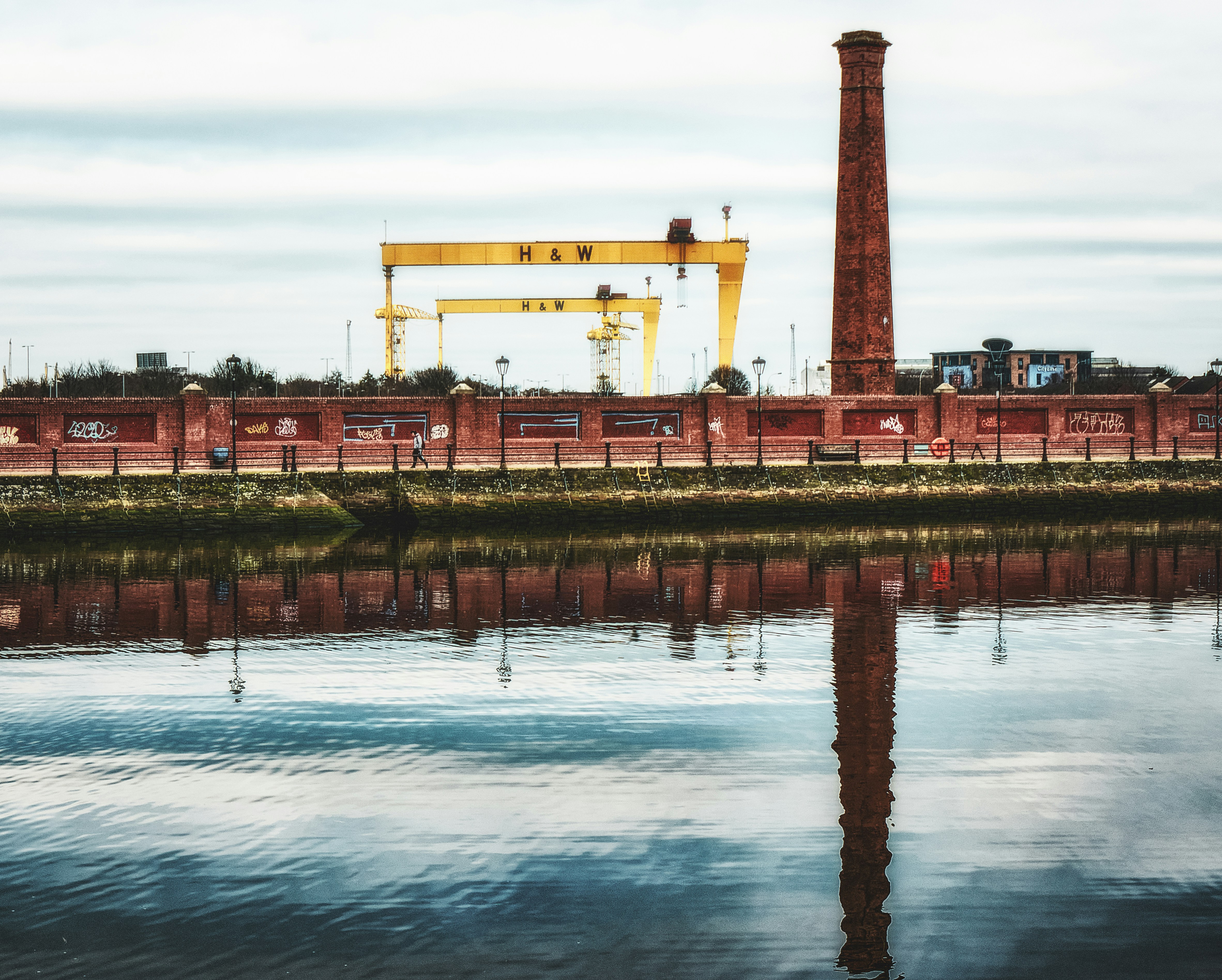 a large crane sitting next to a body of water