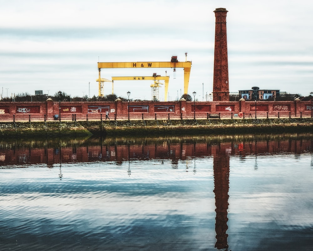 a large crane sitting next to a body of water