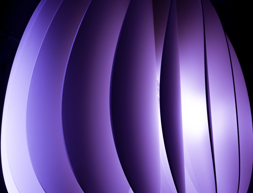 a close up of a purple object with a black background