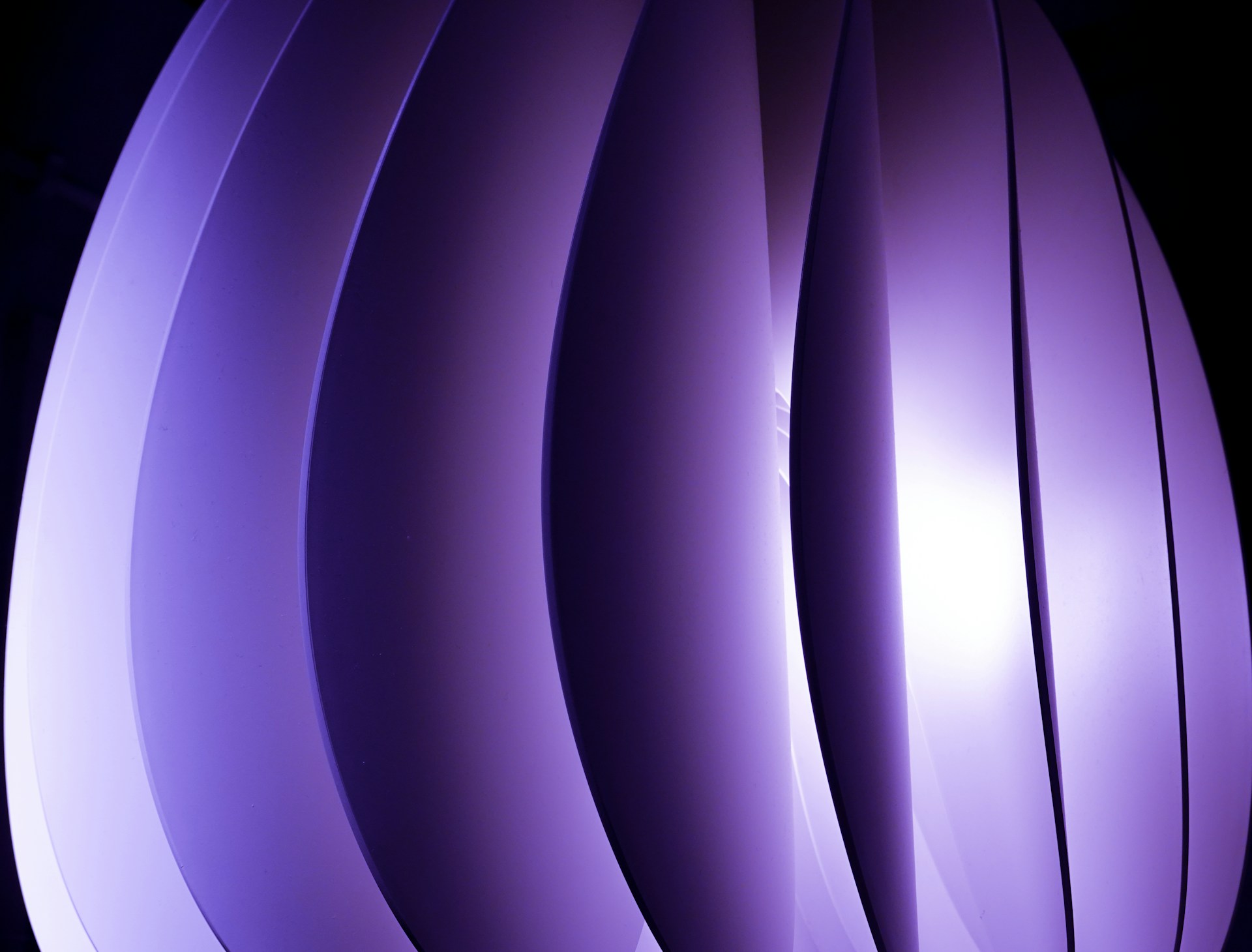 a close up of a purple object with a black background