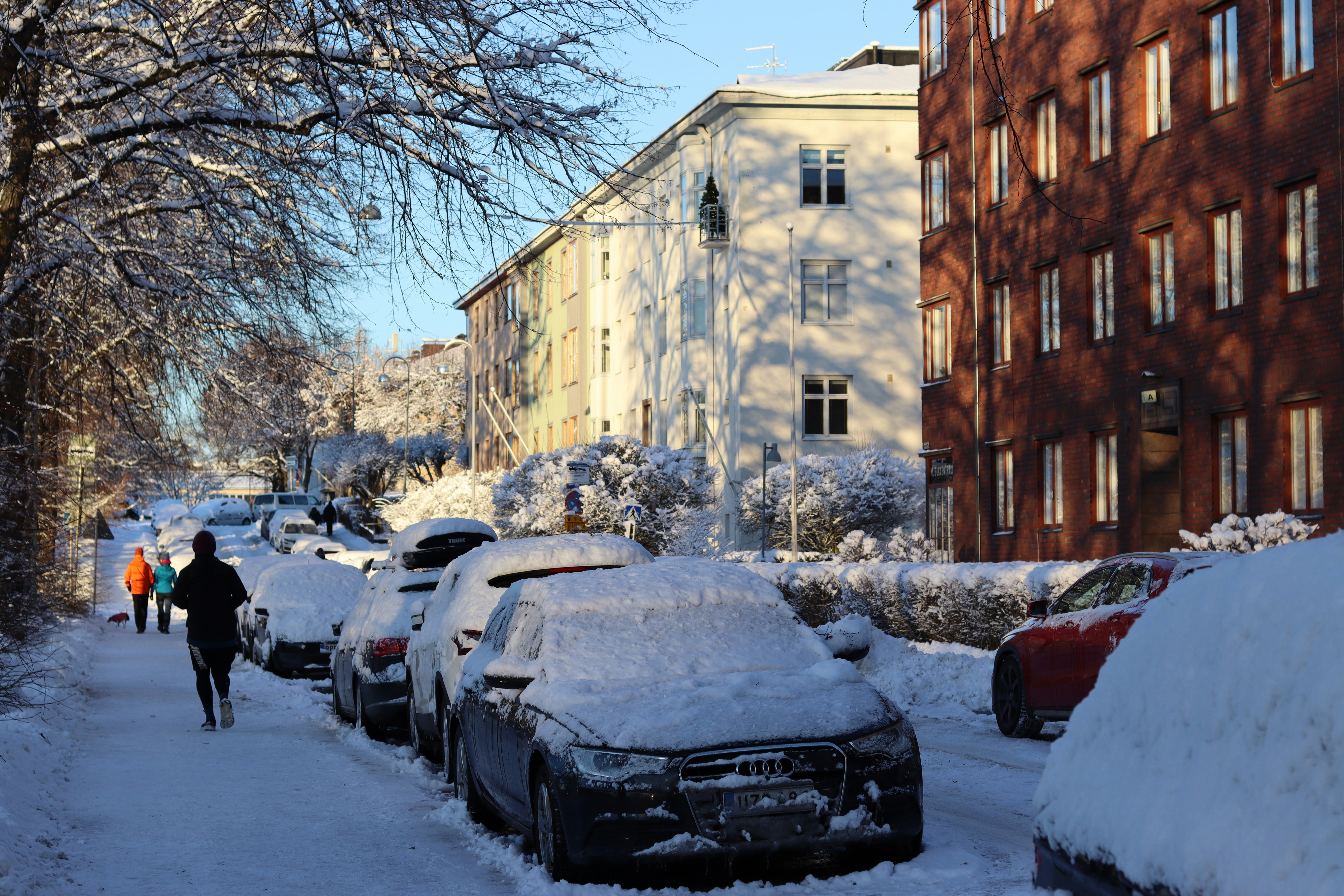 a person walking down a snow covered street