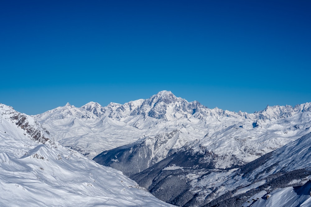 a view of a snowy mountain range from a ski slope