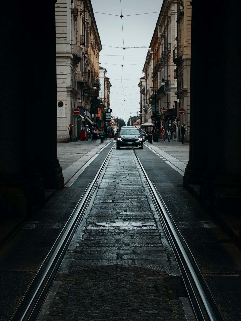 a car driving down a street next to tall buildings