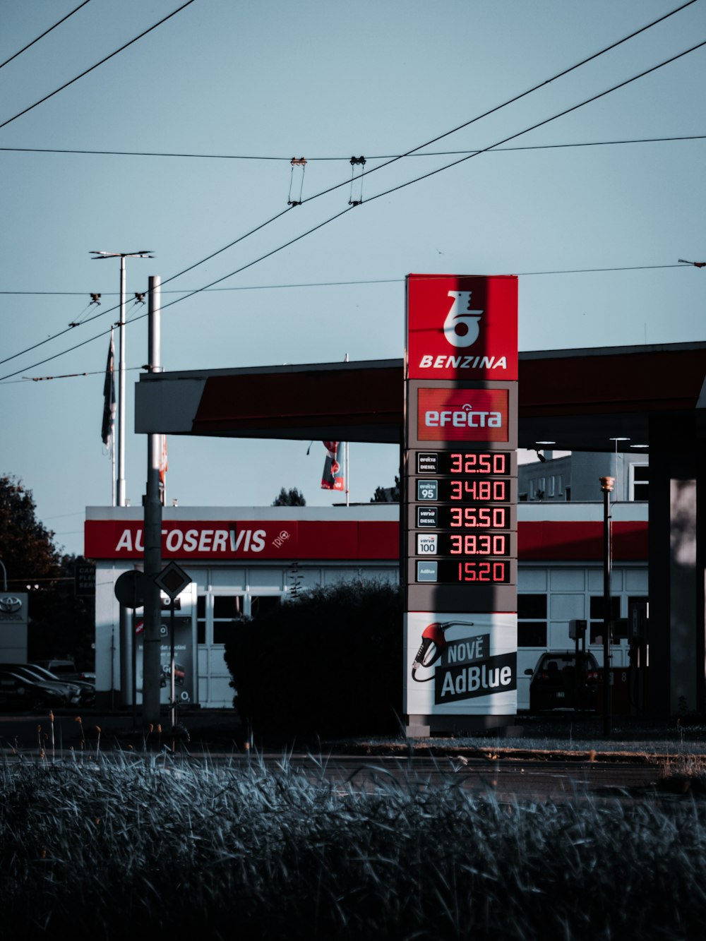 a gas station with a red and white sign
