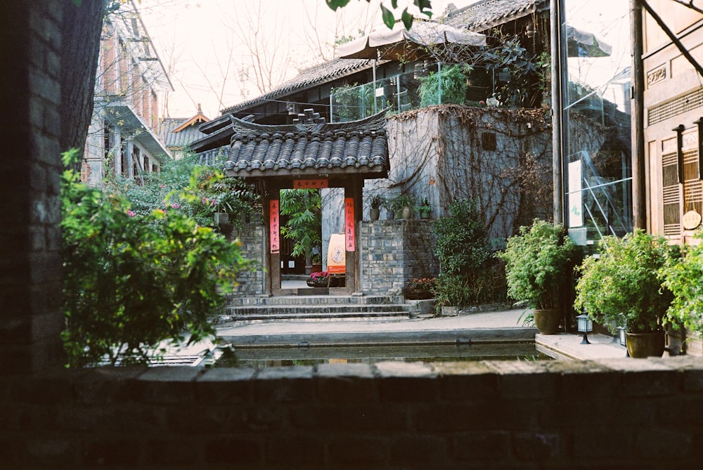 a stone building with a red door in front of it