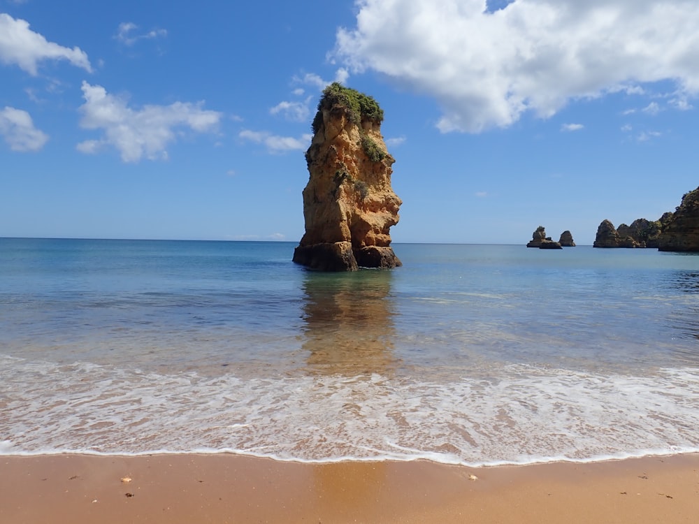 a large rock sticking out of the ocean