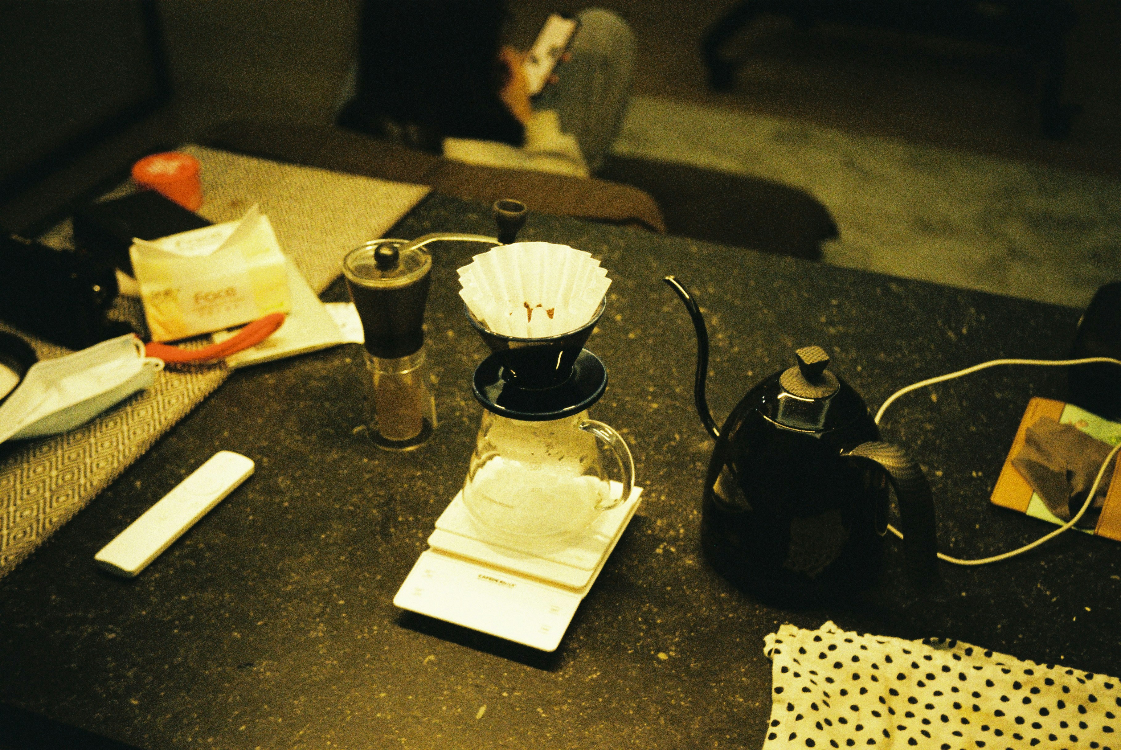 A Table Topped With A Coffee Pot Next To A Cup Of Coffee