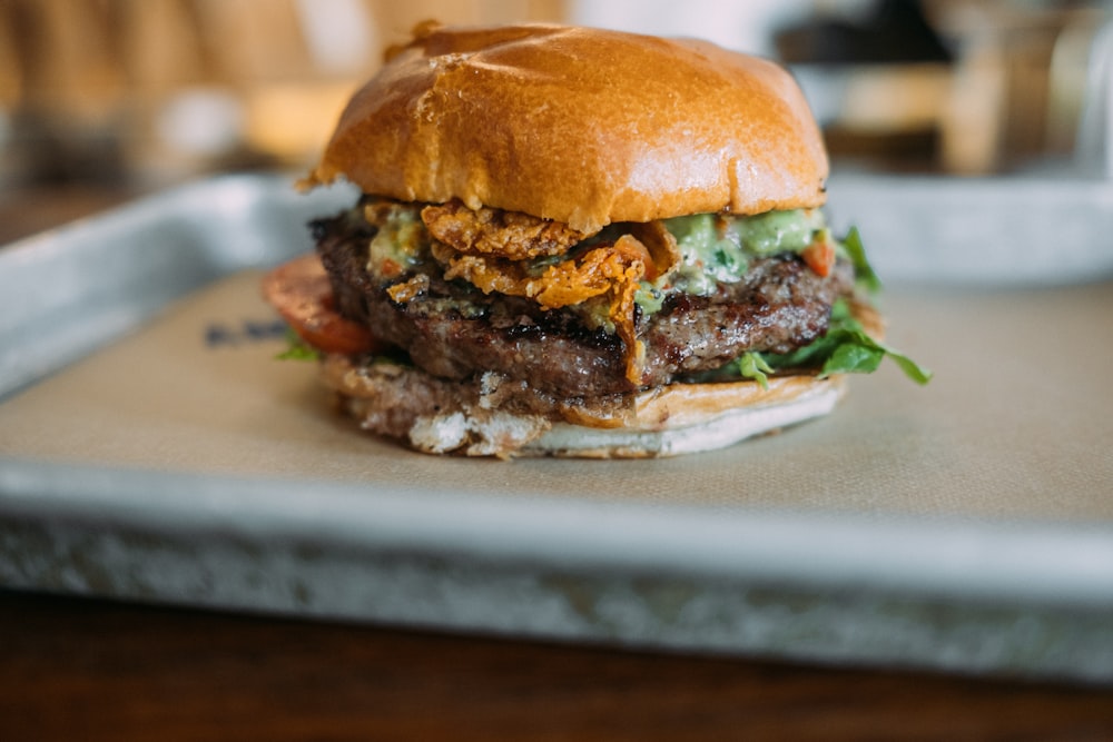 a large hamburger sitting on top of a tray